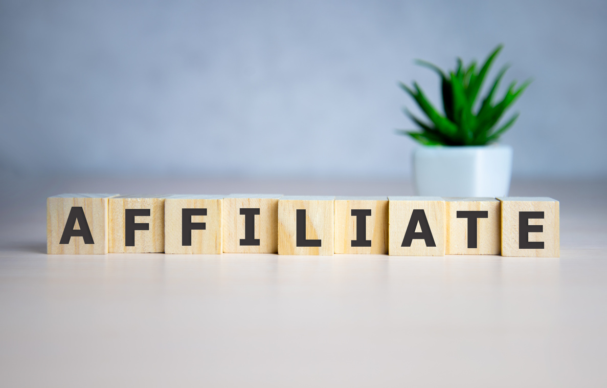 AFFILIATE word made with building blocks on blue.